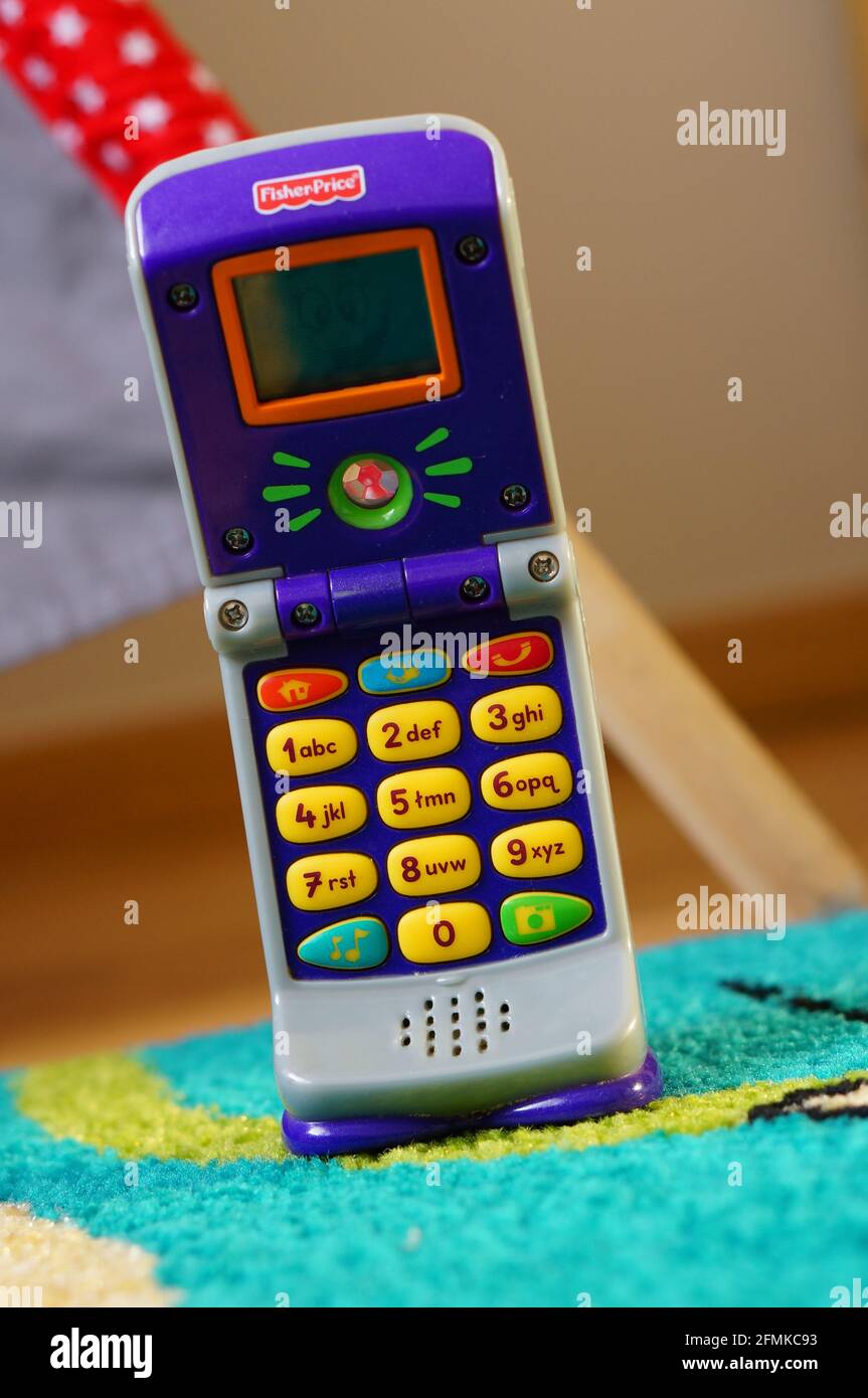 POZNAN, POLAND - Aug 23, 2015: Fisher Price plastic toy phone for kids with buttons. Stock Photo
