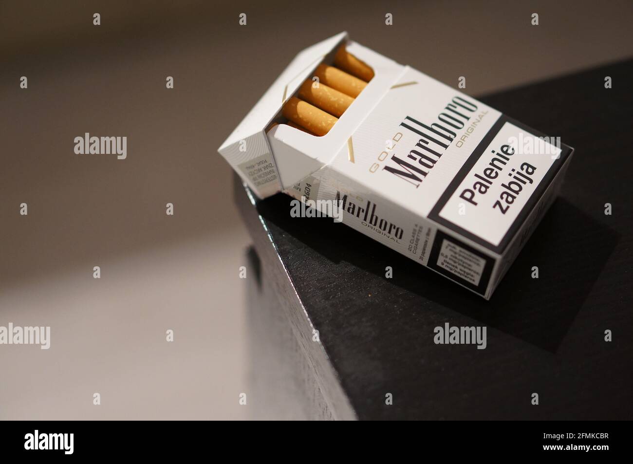 how much is a packet of cigarettes in poland POZNAN, POLAND - Dec 19, 2012: A open box of cigarettes lying on a wooden  table. Besides that smoking is getting every year more expensive Stock  Photo