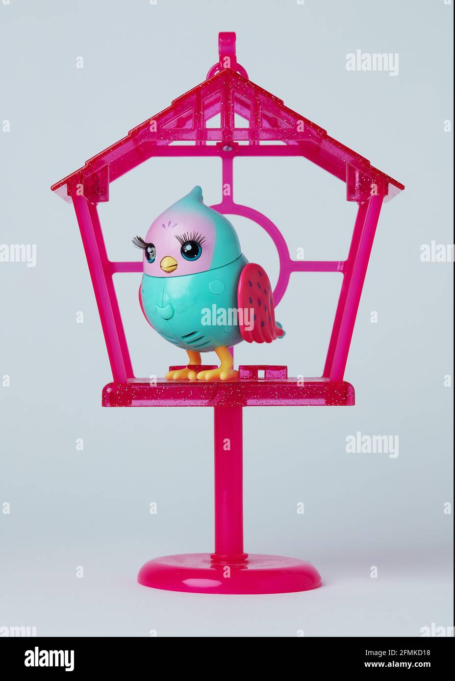 Singing bird toy in birdhouse Stock Photo