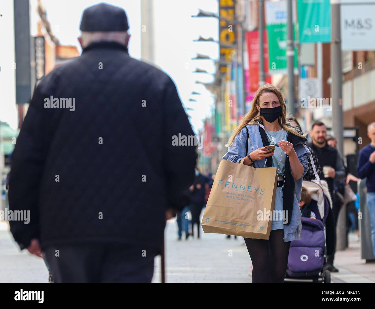 Shoppers with bags in Dublin City centre following the phased reopening of  non-essential retail, with click-and-collect services and in-store shopping  by appointment allowed, while close contact services, such as hairdressers,  can resume
