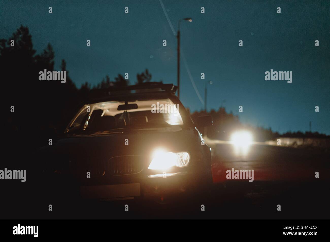 Night beam of classic car. Stop at long trip Stock Photo