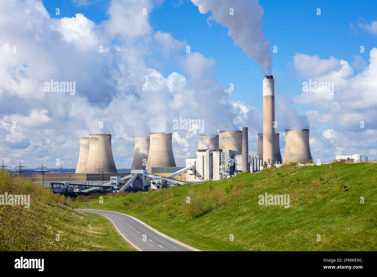 Winding road by Ratcliffe-on-Soar power station coal-fired with steam from the cooling towers Ratcliffe on soar Nottinghamshire England UK GB Europe Stock Photo