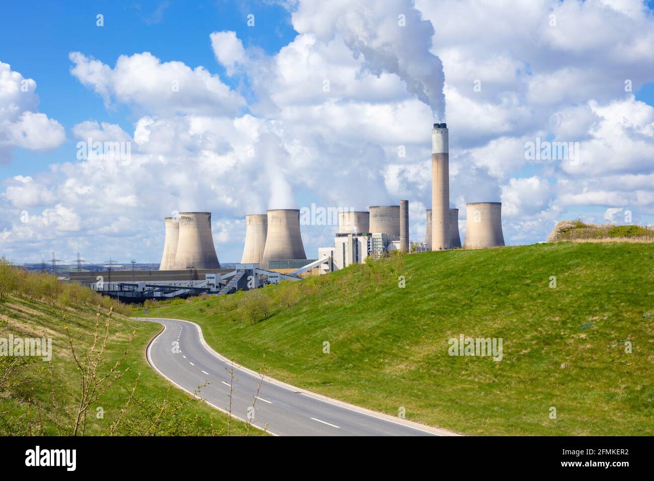 Winding road by Ratcliffe-on-Soar coal power station with steam from the cooling towers Ratcliffe on soar Nottinghamshire England UK GB Europe Stock Photo