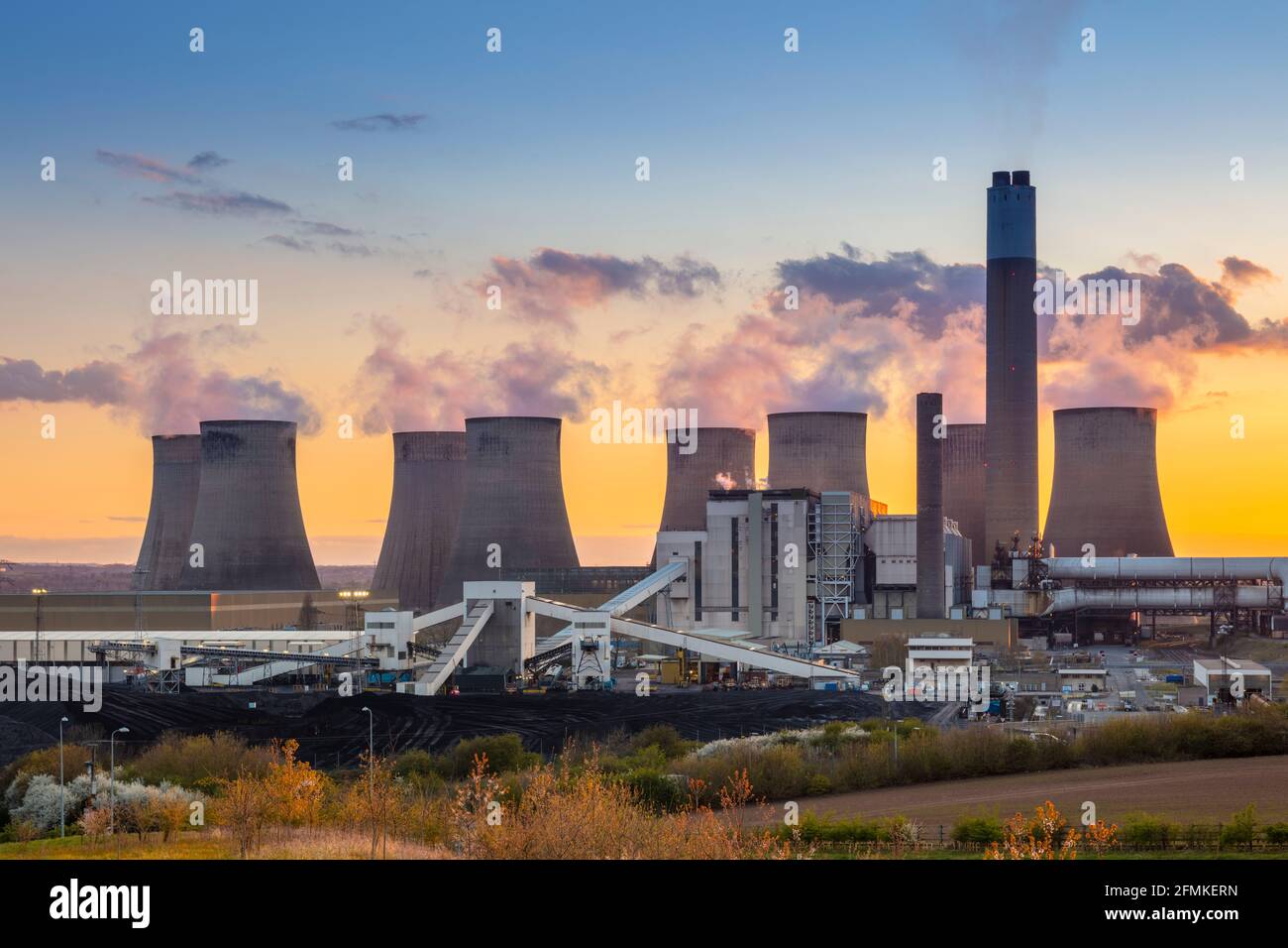 Ratcliffe-on-Soar coal power station with steam from the cooling towers at sunset Ratcliffe on soar Nottinghamshire England UK GB Europe Stock Photo