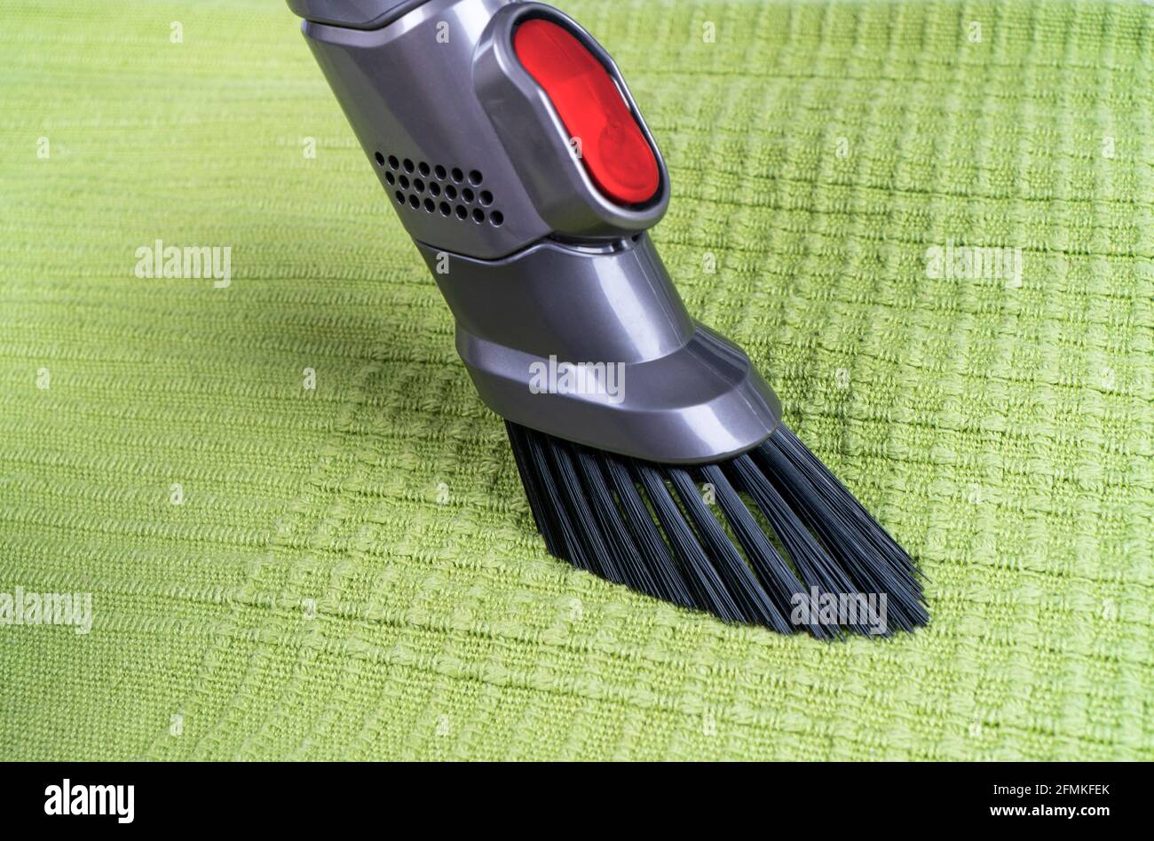 Removing dirt from sofa with upholstery cleaner. Sofa chemical cleaning. Upholstered furniture