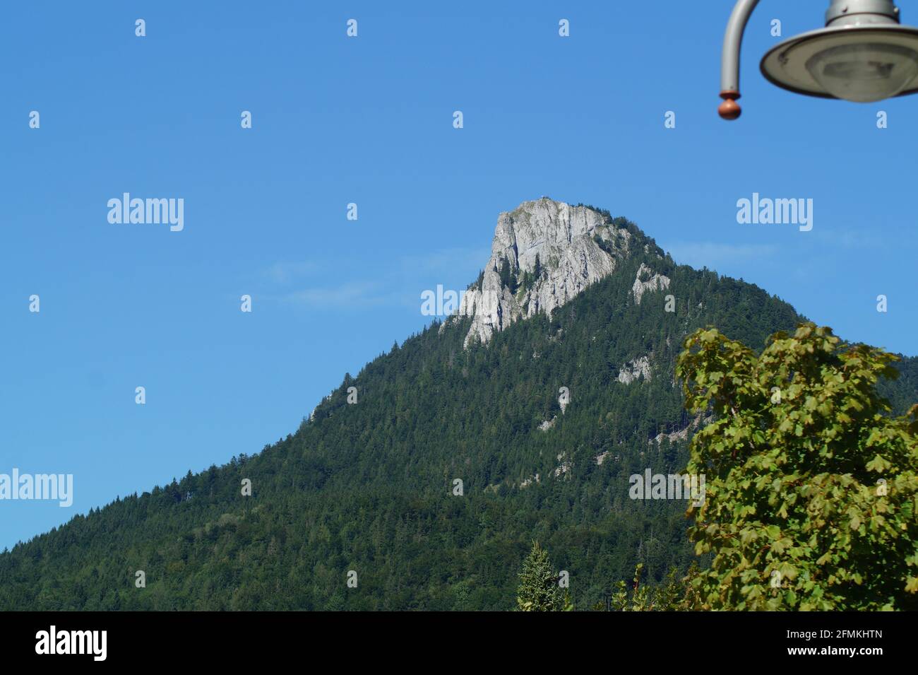 Scenic mountain forest on blue sky background Stock Photo - Alamy
