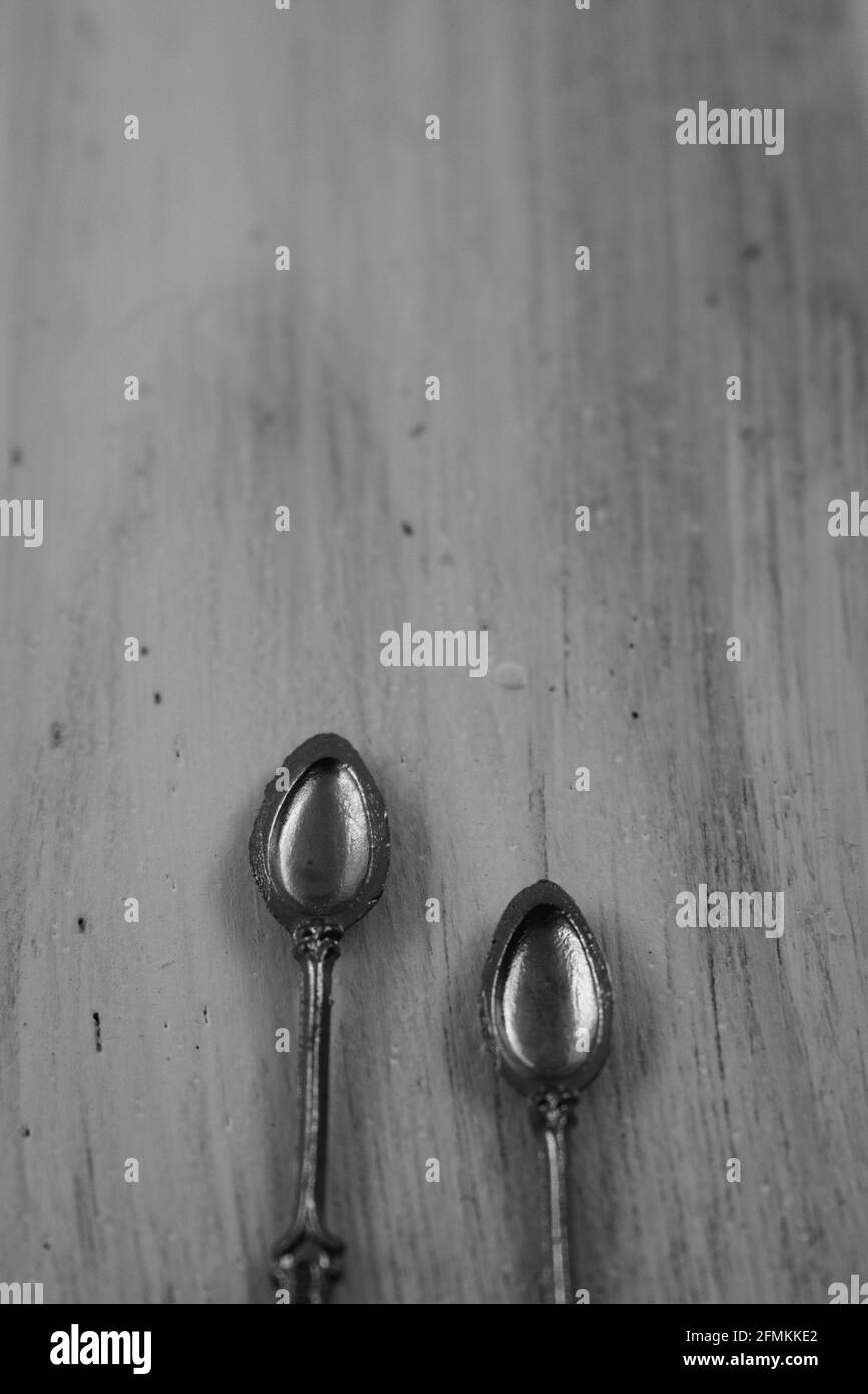 Two silver spoons over vintage wooden background with copy space Stock Photo
