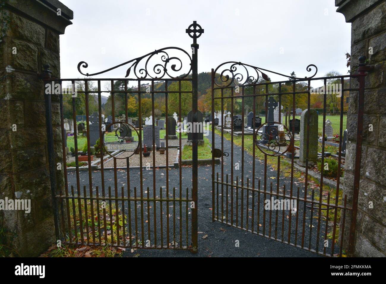 Column Cemetary Gate Antique handcrafted iron entrance gate with stone columns at St. Kevin ...