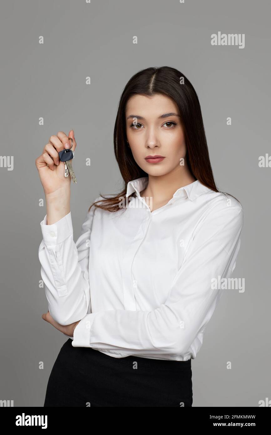 beautiful young brunette woman holding house keys Stock Photo - Alamy