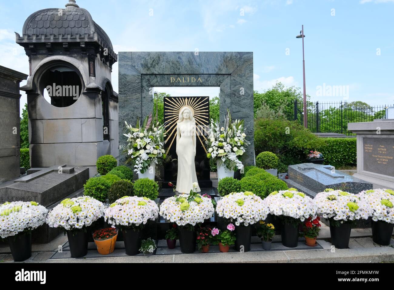 PARIS, FRANCE - MAY 09, 2021: Montmartre Cemetery in Paris, Dalida famous French singer and actress grave, monument with beautiful white flower bouque Stock Photo