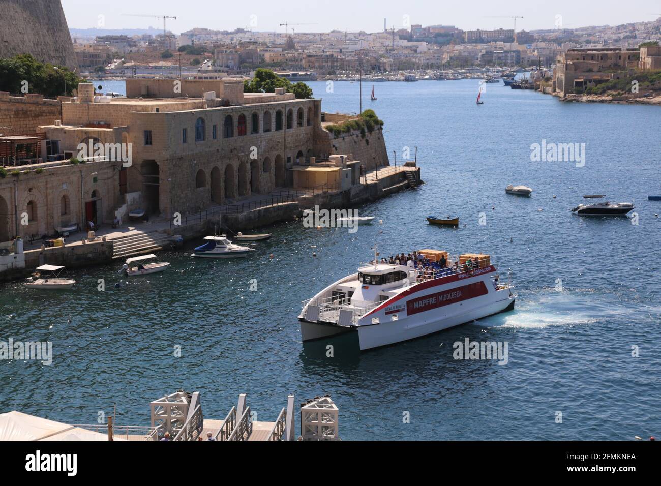 Velletta. Malta. Sliema-Valletta ferry crossing Marsamxett Harbour seen from Valletta coast. Stock Photo