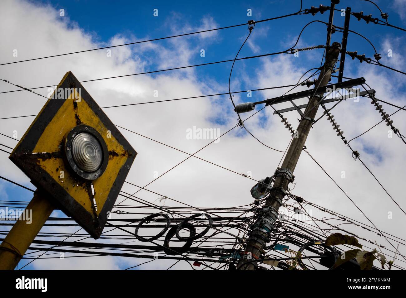 Low-angle shot of power lines against the cloudy sky Stock Photo - Alamy