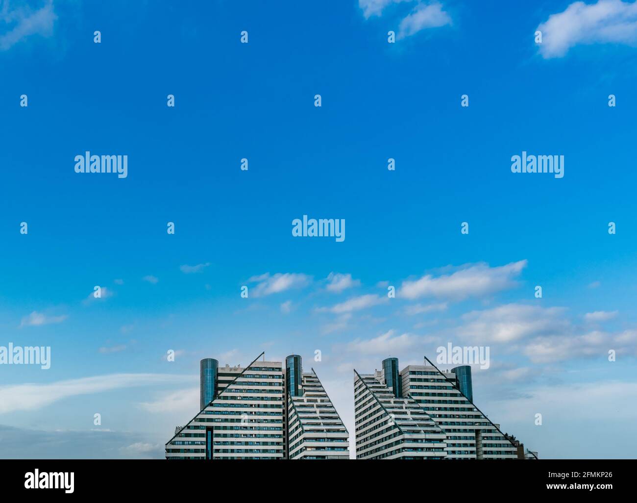 Modern buildings under clear blue sky for text space Stock Photo - Alamy