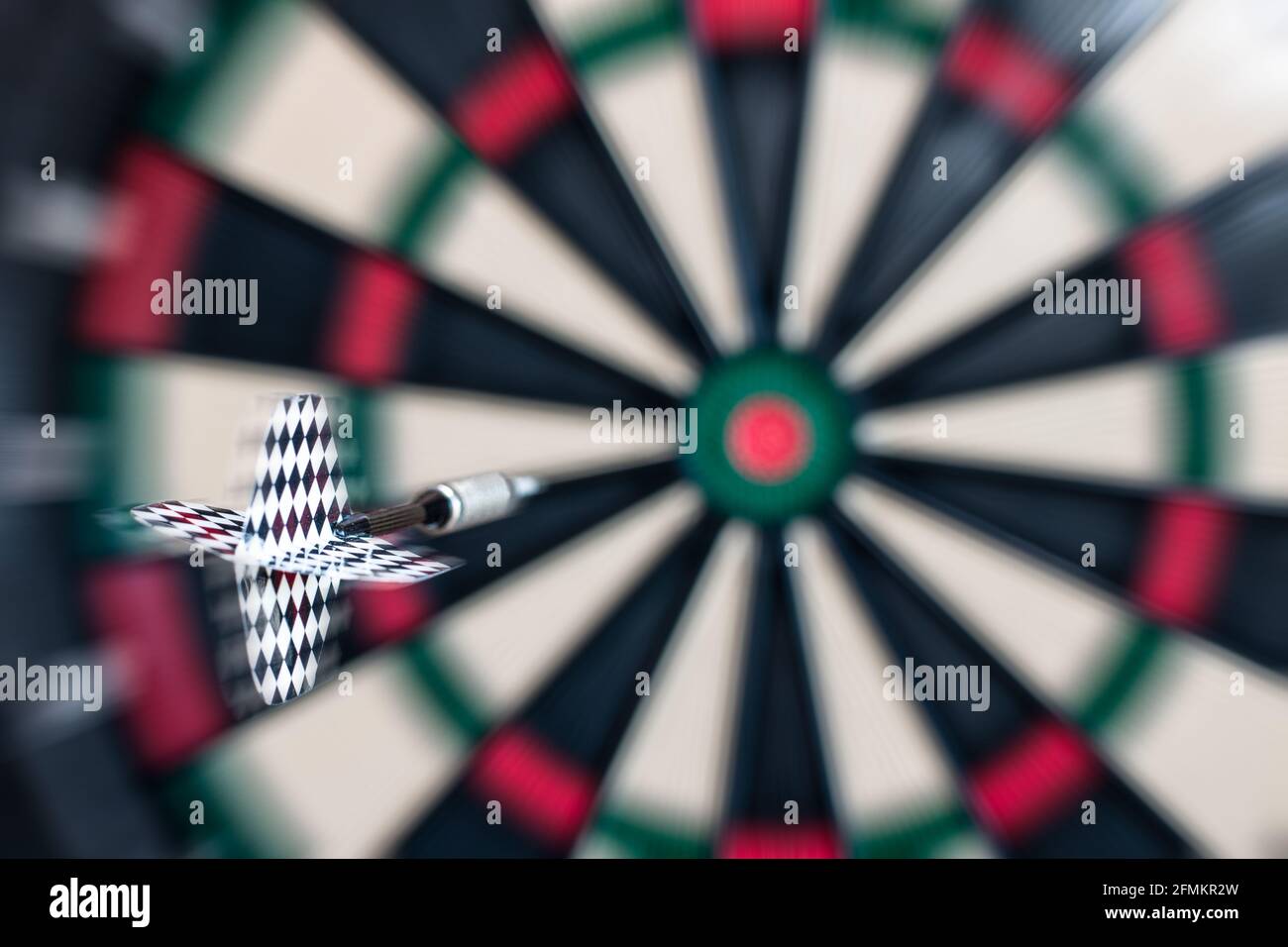 Blurred motion image of a dart flying towards the bull's eye of a target. Playing concept Stock Photo