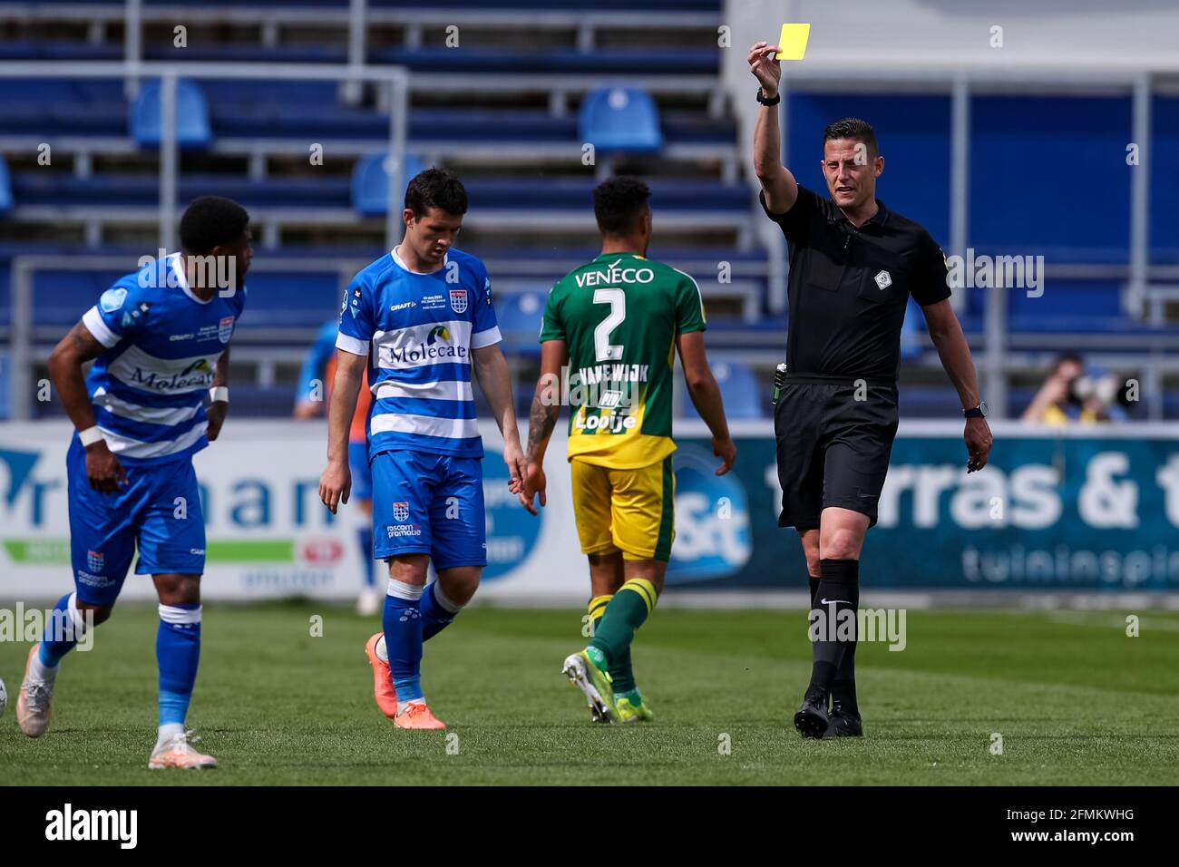 ZWOLLE, NETHERLANDS - MAY 9: Referee Jeroen Manschot shows a yellow card to Kenneth Paal of PEC Zwolle during the Dutch Eredivisie match between PEC Z Stock Photo
