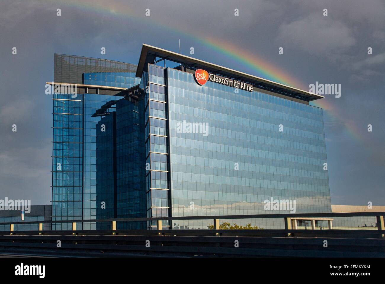 A rainbow over the Glaxo Smith Kline headquarters in London Stock Photo
