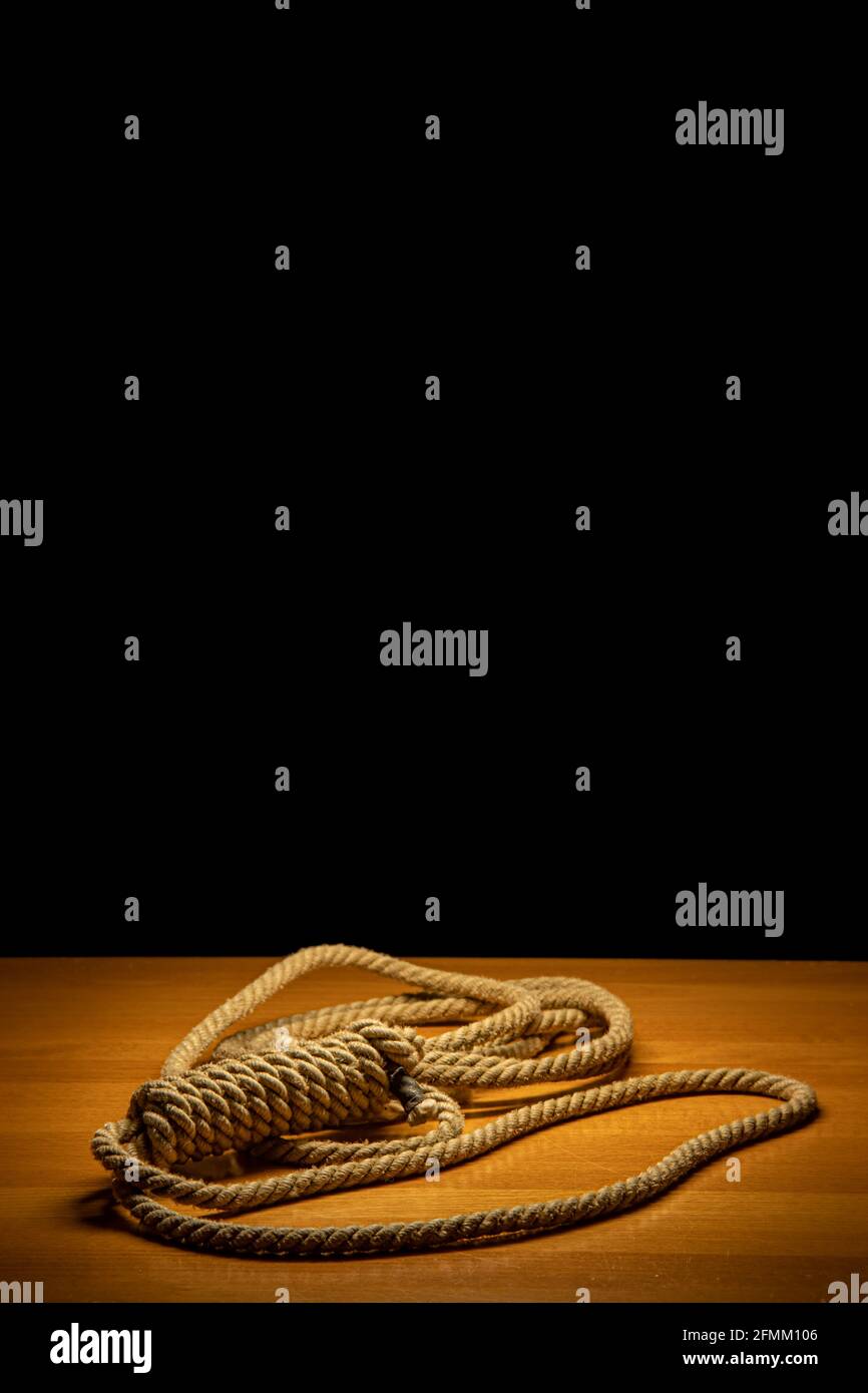 A noose lying on the table, on a black background Stock Photo