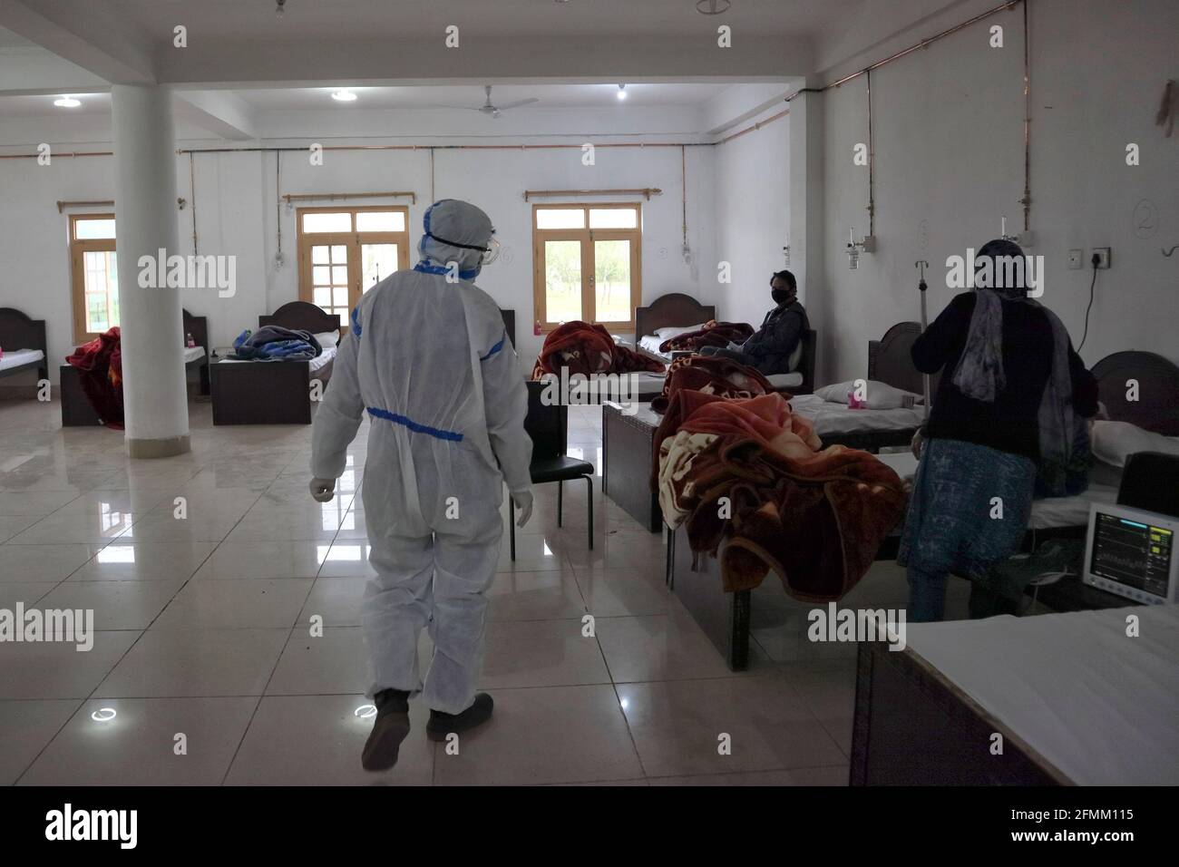 May 8, 2021: A Health worker examins Covid-19 patients at a temporary Covid-19 hospital in Srinagar, Indian Administered Kashmir on 08 May 2021. A Local NGO Athrout has converted Hajj house into a 100-bedded Covid centre as the space in hospitals is filling up fast Credit: Muzamil Mattoo/IMAGESLIVE/ZUMA Wire/Alamy Live News Stock Photo