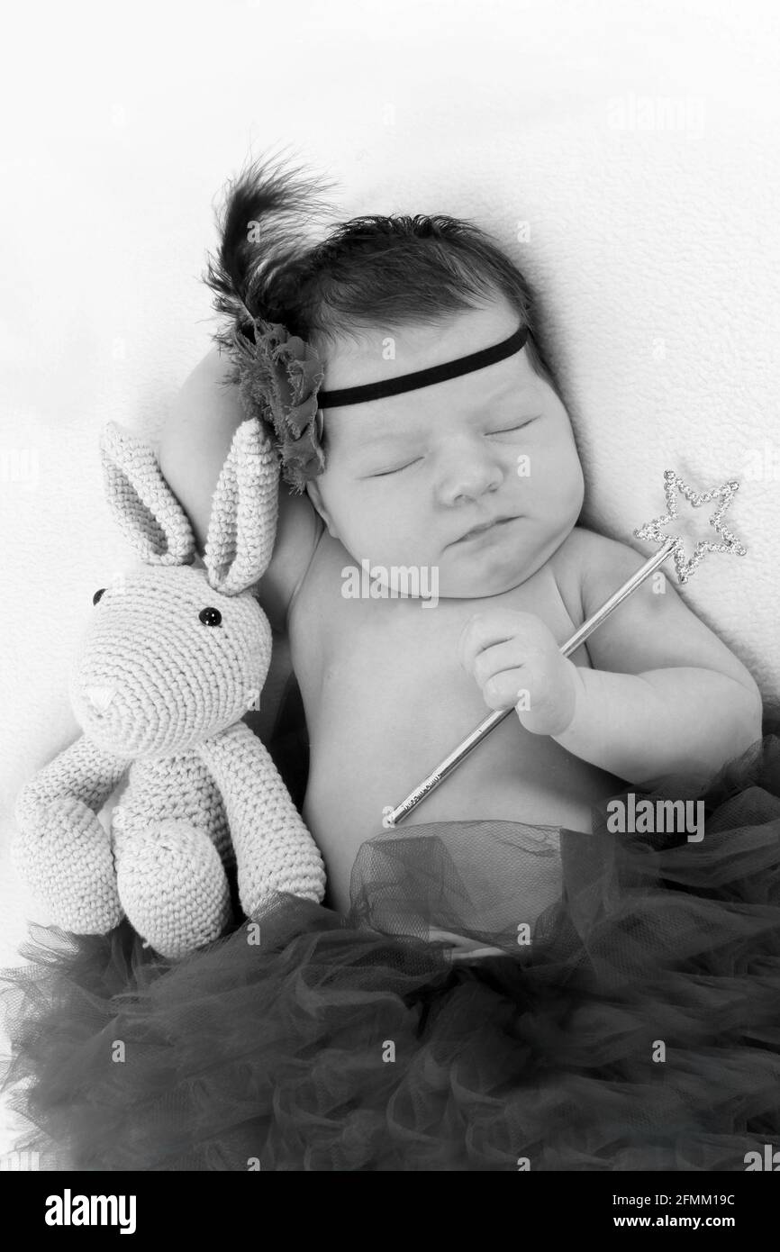 1 week old baby girl sleeping on a blanket in the nursery, newborn baby