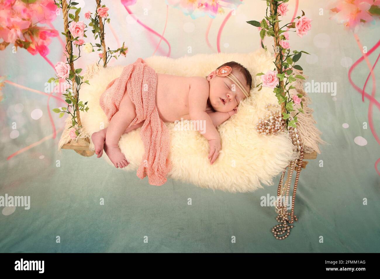 newborn Baby Sleeping on a swing, dreaming, restful sleep in a dream