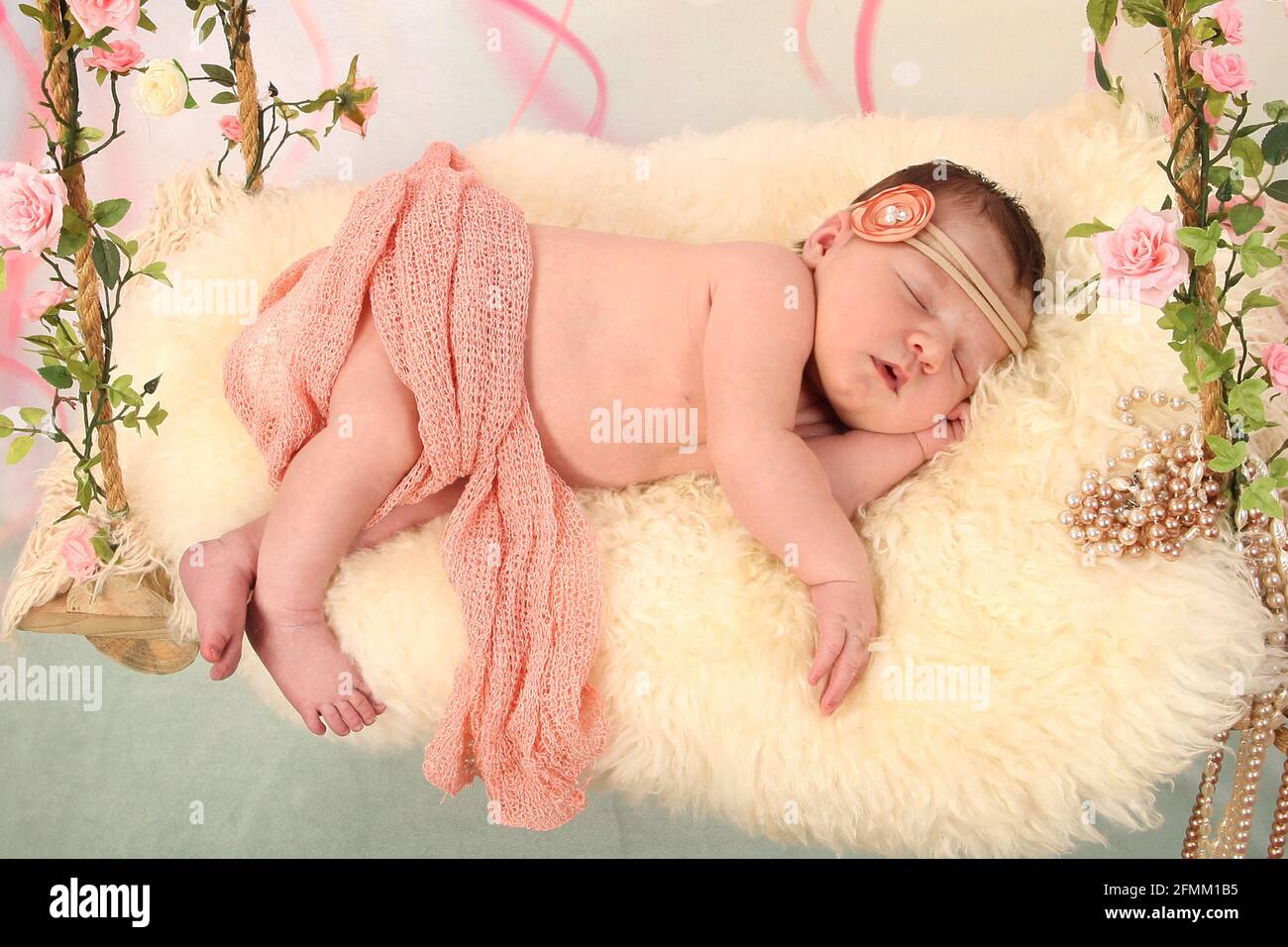 newborn Baby Sleeping on a swing, dreaming, restful sleep in a dream