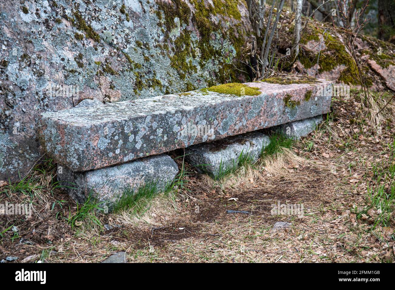 Moss and lichen covered stone bench in Seurasaari Island, Helsinki, Finland Stock Photo