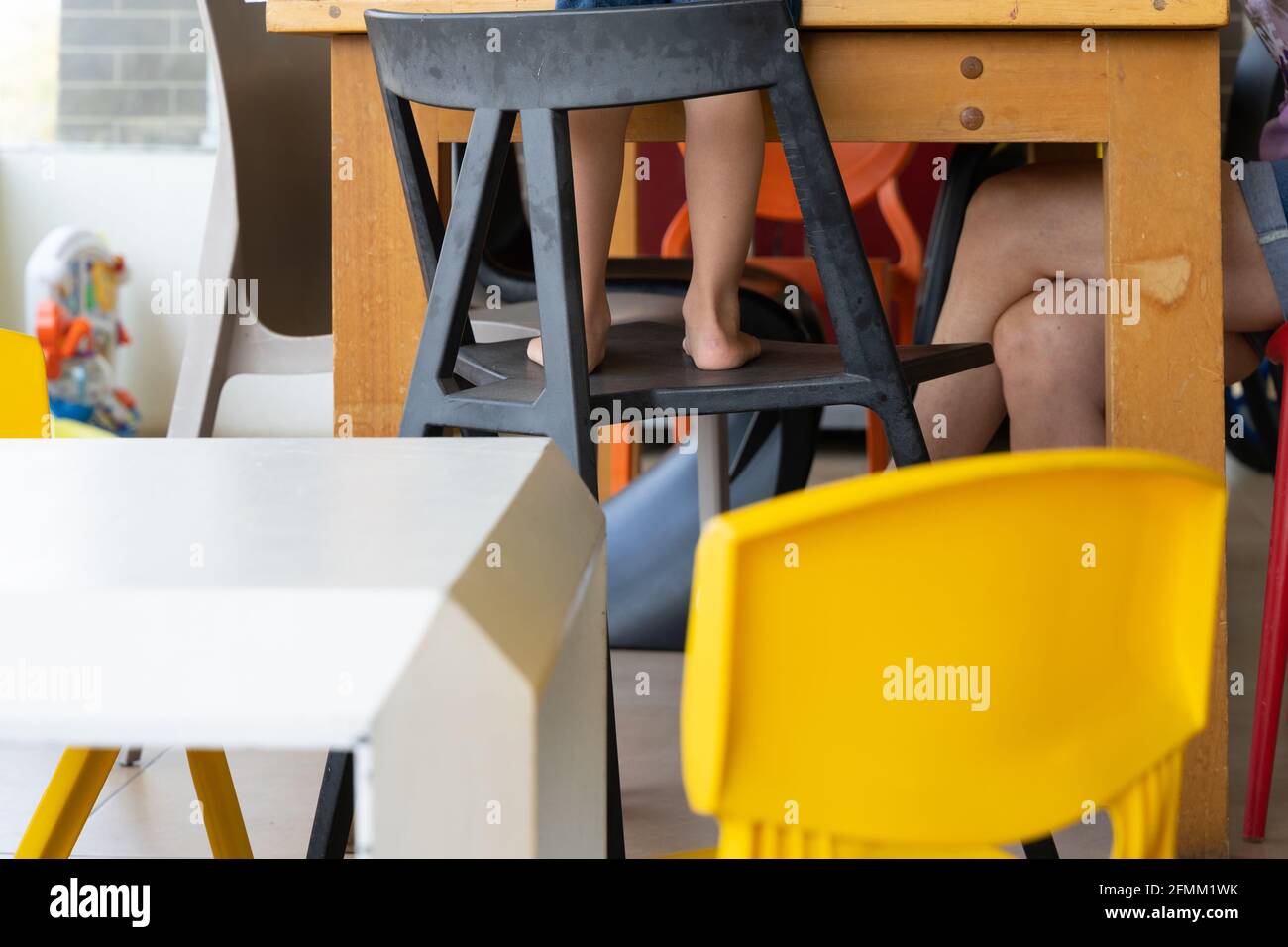 Legs of little boy standing on chair at school. Home schooling, education concepts Stock Photo