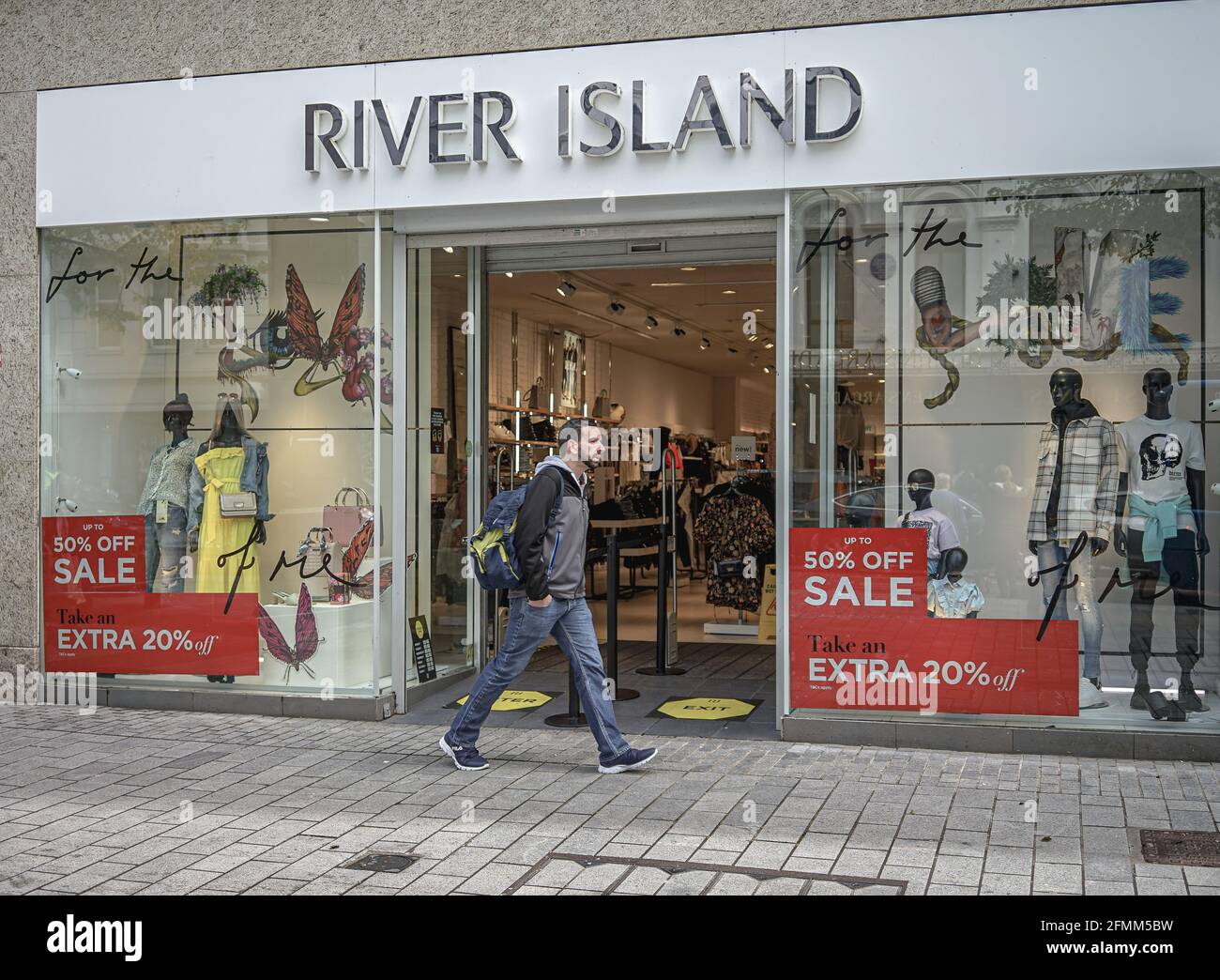 A shopper seen walking past the River Island Clothes Store Stock Photo Alamy