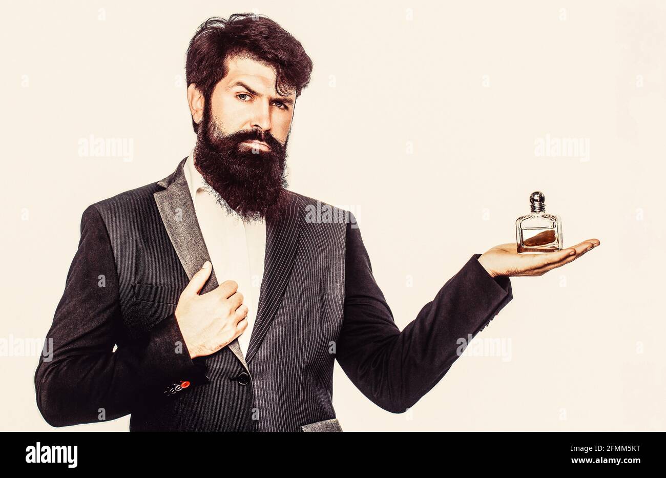 https://c8.alamy.com/comp/2FMM5KT/male-holding-up-bottle-of-perfume-man-perfume-fragrance-perfume-or-cologne-bottle-and-perfumery-cosmetics-scent-cologne-bottle-male-holding-2FMM5KT.jpg