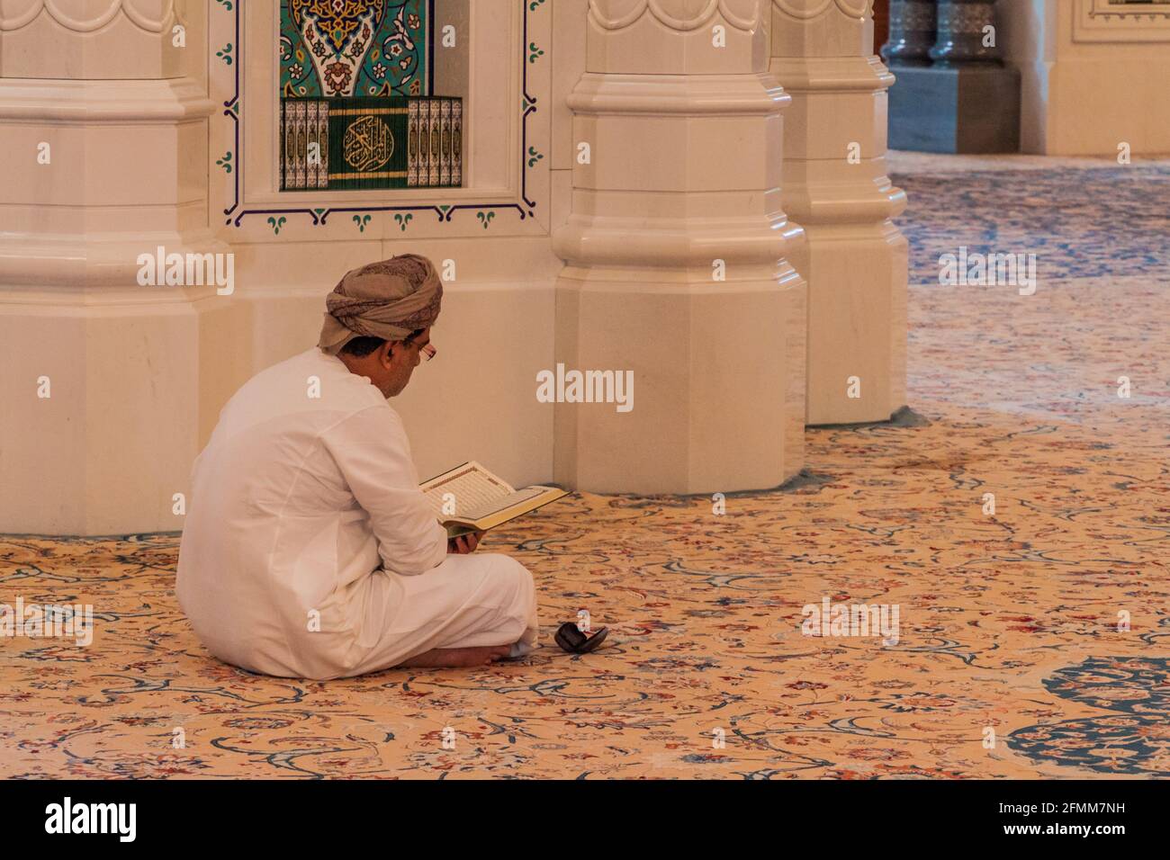 MUSCAT, OMAN - FEBRUARY 22, 2017: Local man in Sultan Qaboos Grand Mosque in Muscat, Oman Stock Photo