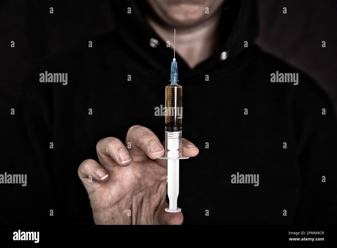 heroin addiction Junky shooting up Horse with syringe on dark background, Drugs,Junk,teen,addict concept Stock Photo