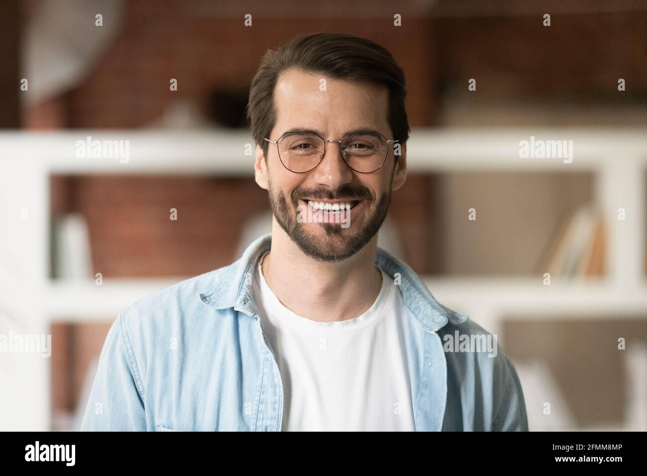 Head shot portrait confident smiling bearded businessman in glasses Stock Photo