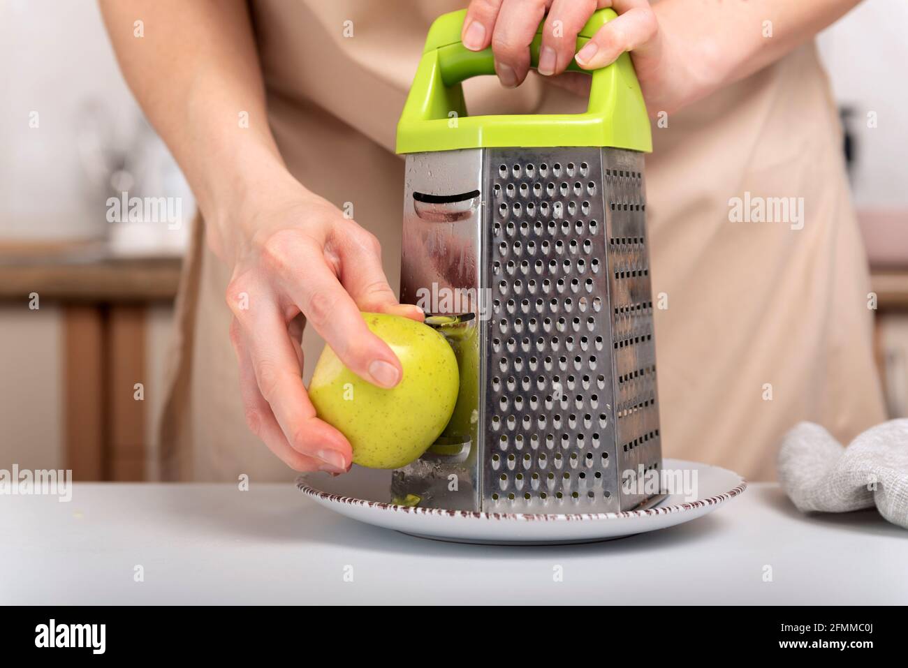 Process of grinding an apple on a grater. Baking ingredients, chef's hands  Stock Photo - Alamy
