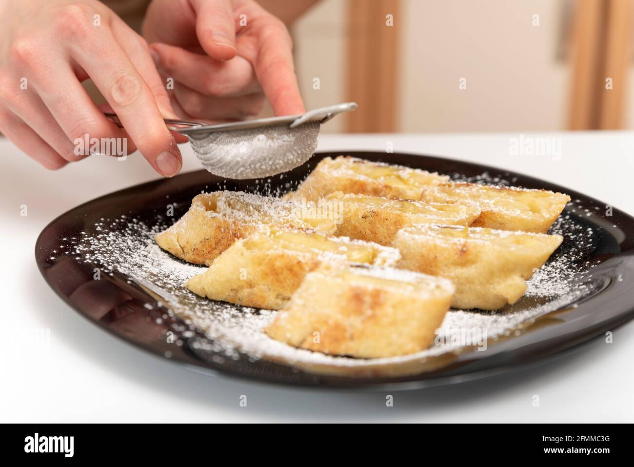 Chef sprinkles icing sugar on the apple roll. Strudel feed Stock Photo ...