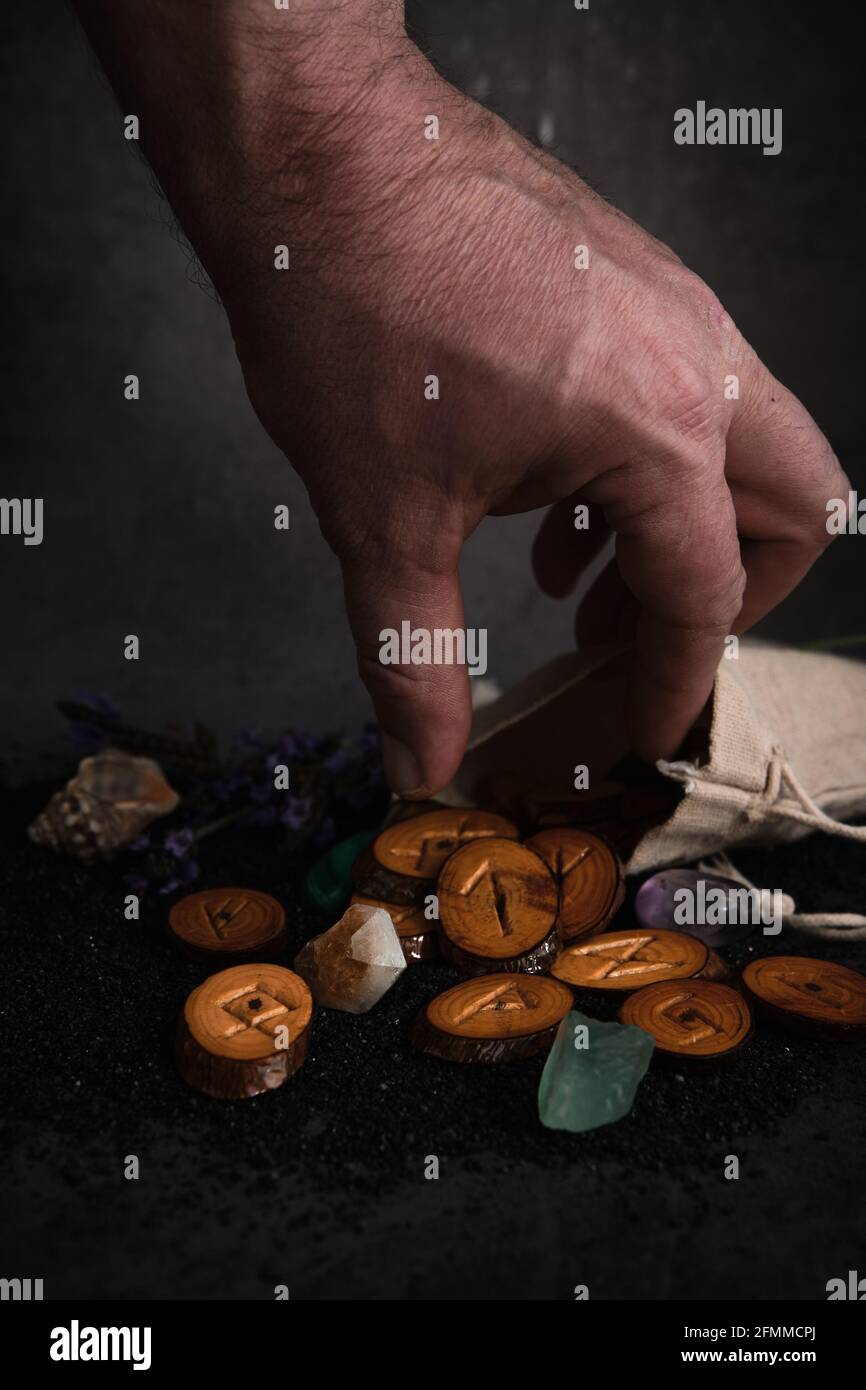 homemade wooden runes on a dark background Stock Photo - Alamy