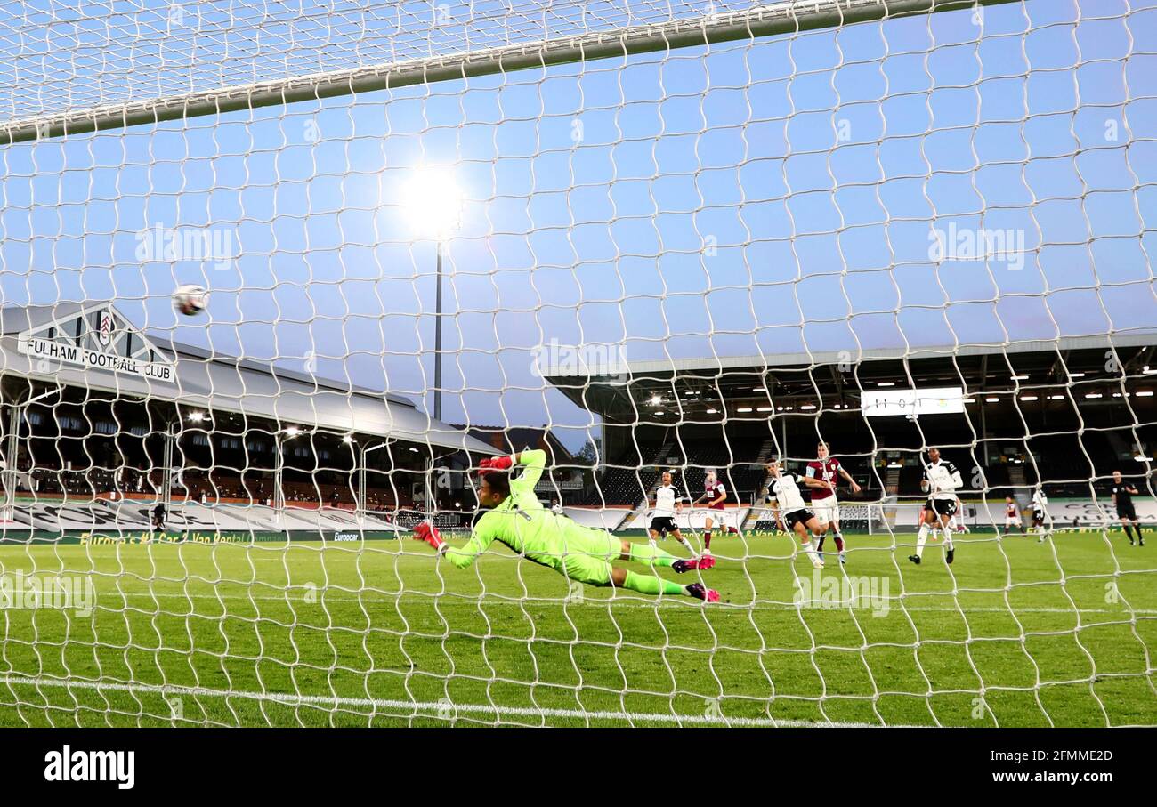 Burnley's Chris Wood scores their side's second goal of the game during the Premier League match at Craven Cottage, London. Picture date: Monday May 10, 2021. Stock Photo