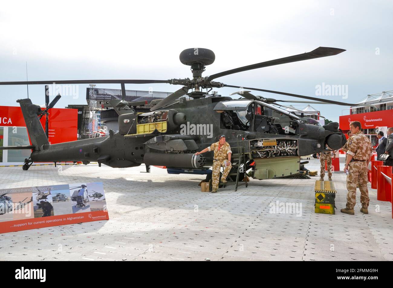 British Army AgustaWestland WAH-64 Apache gunship on display at Farnborough International Airshow. Weapons. Defence industry. Military personnel, crew Stock Photo