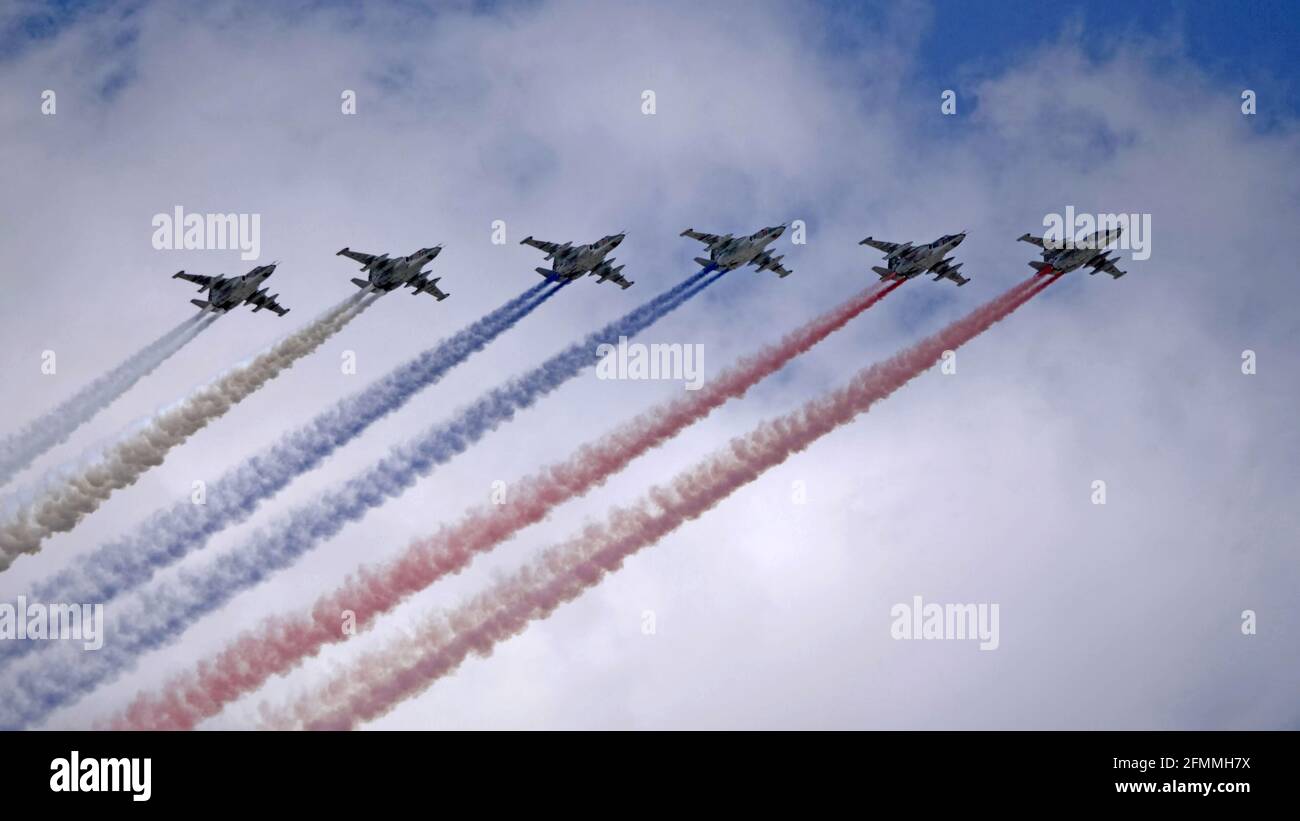 MOSCOW, RUSSIA - MAY 7, 2021: Avia parade in Moscow. Group of Russian fighters Sukhoi Su-25 with painted russian flag in the sky on parade of Victory Stock Photo