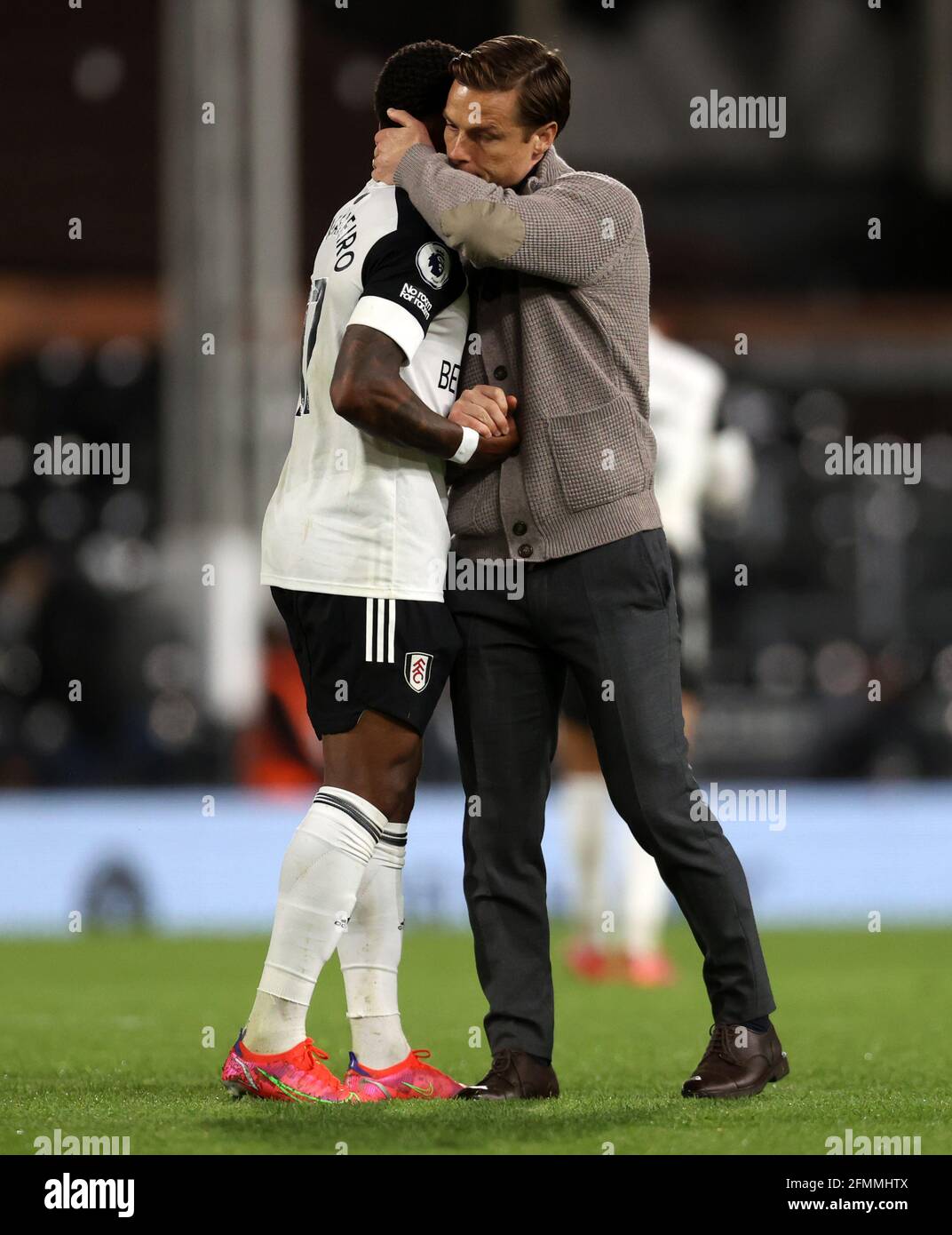Fulham manager Scott Parker consoles Ricardo Ivan Cavaleiro after Fulham are relegated during the Premier League match at Craven Cottage, London. Picture date: Monday May 10, 2021. Stock Photo