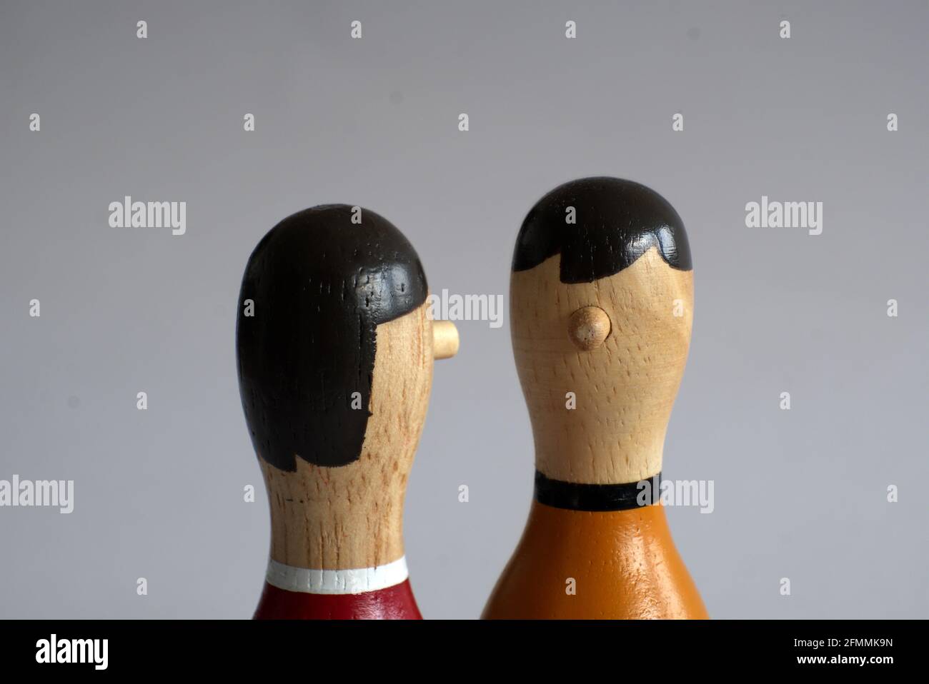 narrow countershot of a dialogue between two wooden puppets Stock Photo