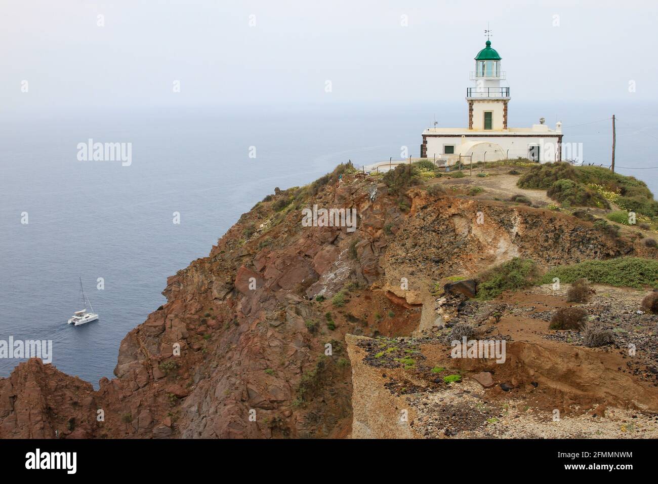 Akrotiri Lighthouse with mist and sea, Santorini, Greece Stock Photo