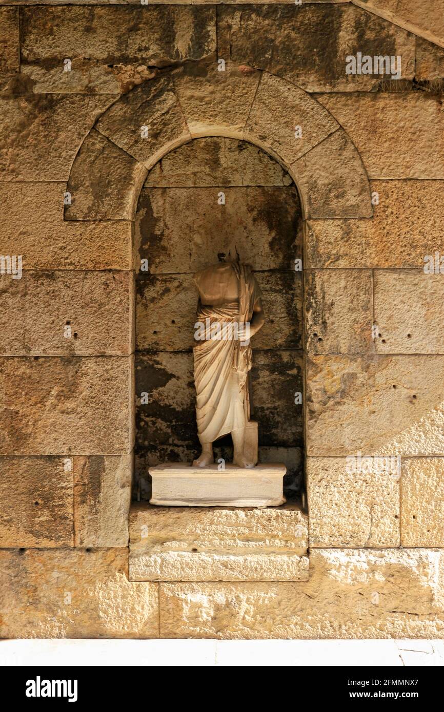 Headless marble sculpture inset in stone wall at Acropolis, Athens, Greece Stock Photo