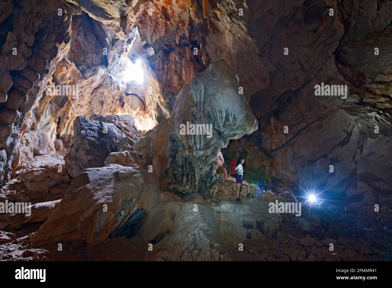 Hiker exploring Anxiety state crisis cave at Crazy Horse buttress Stock Photo