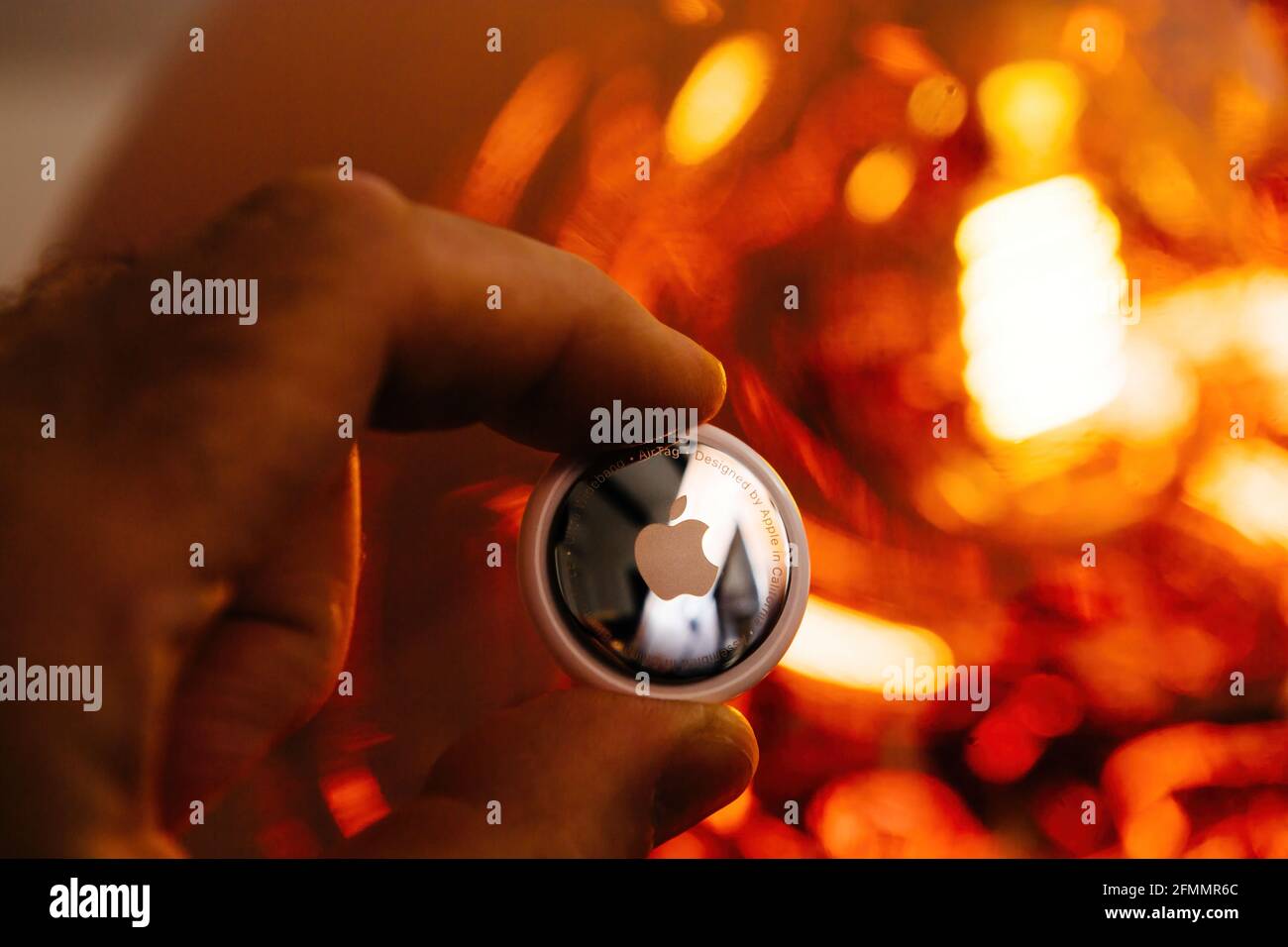 Man pov looking at AirTag with rear engraved text Stock Photo