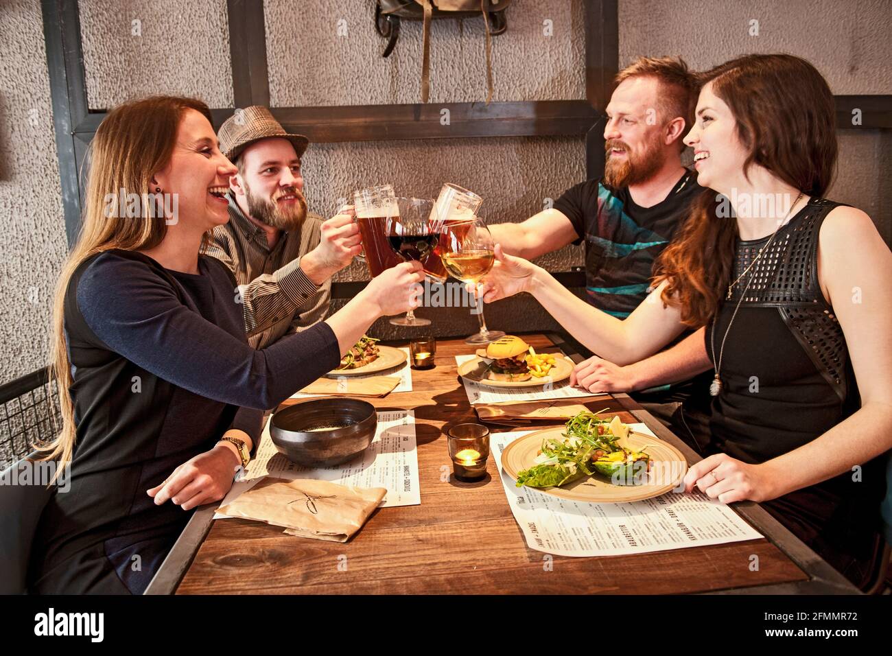 Friends having a good time at hipster bar in Reykjavik Stock Photo