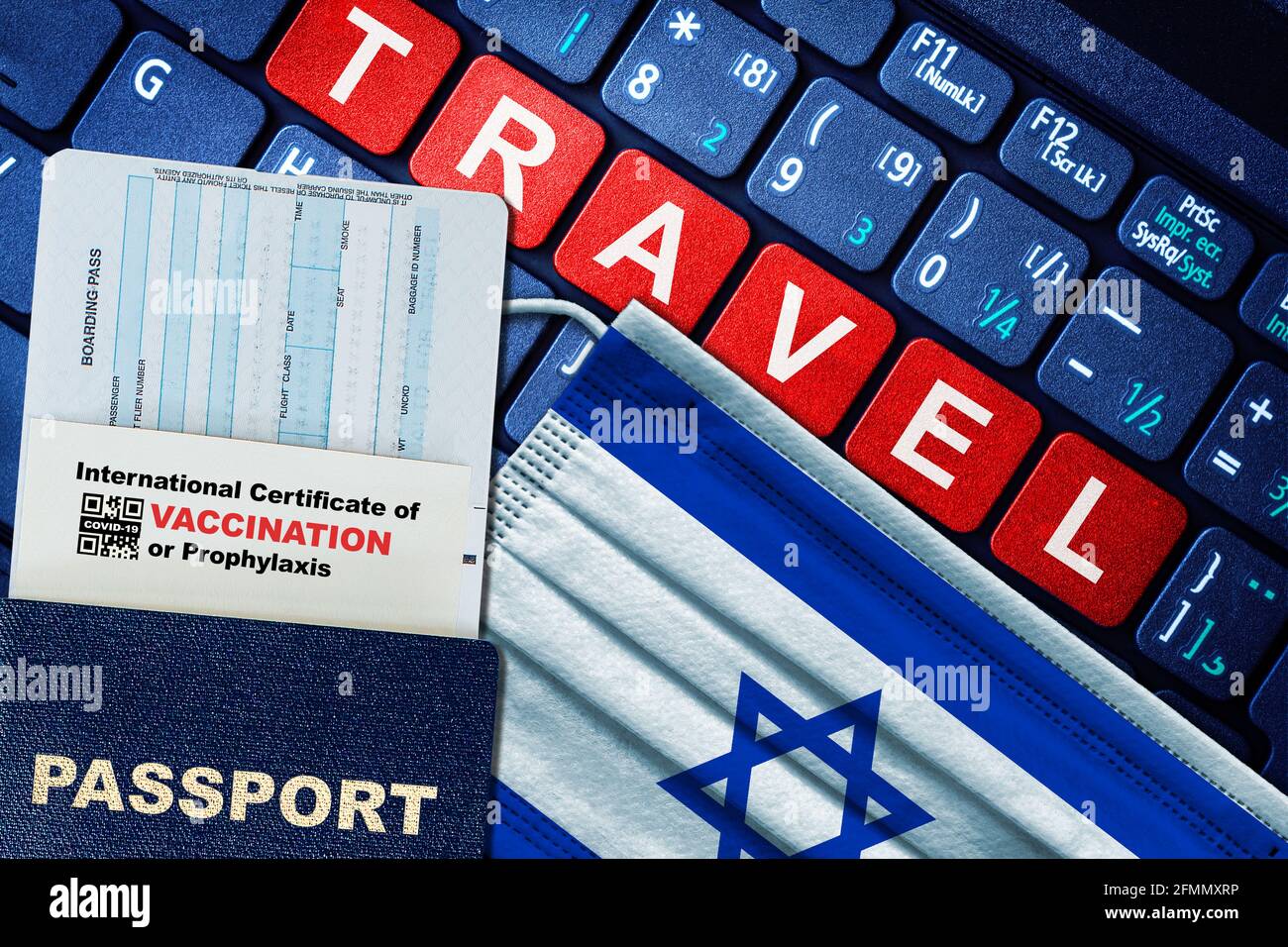 Israel new normal travel concept with passport, boarding pass, face mask with Israeli flag and certificate of COVID-19 vaccination on keyboard. Vaccin Stock Photo
