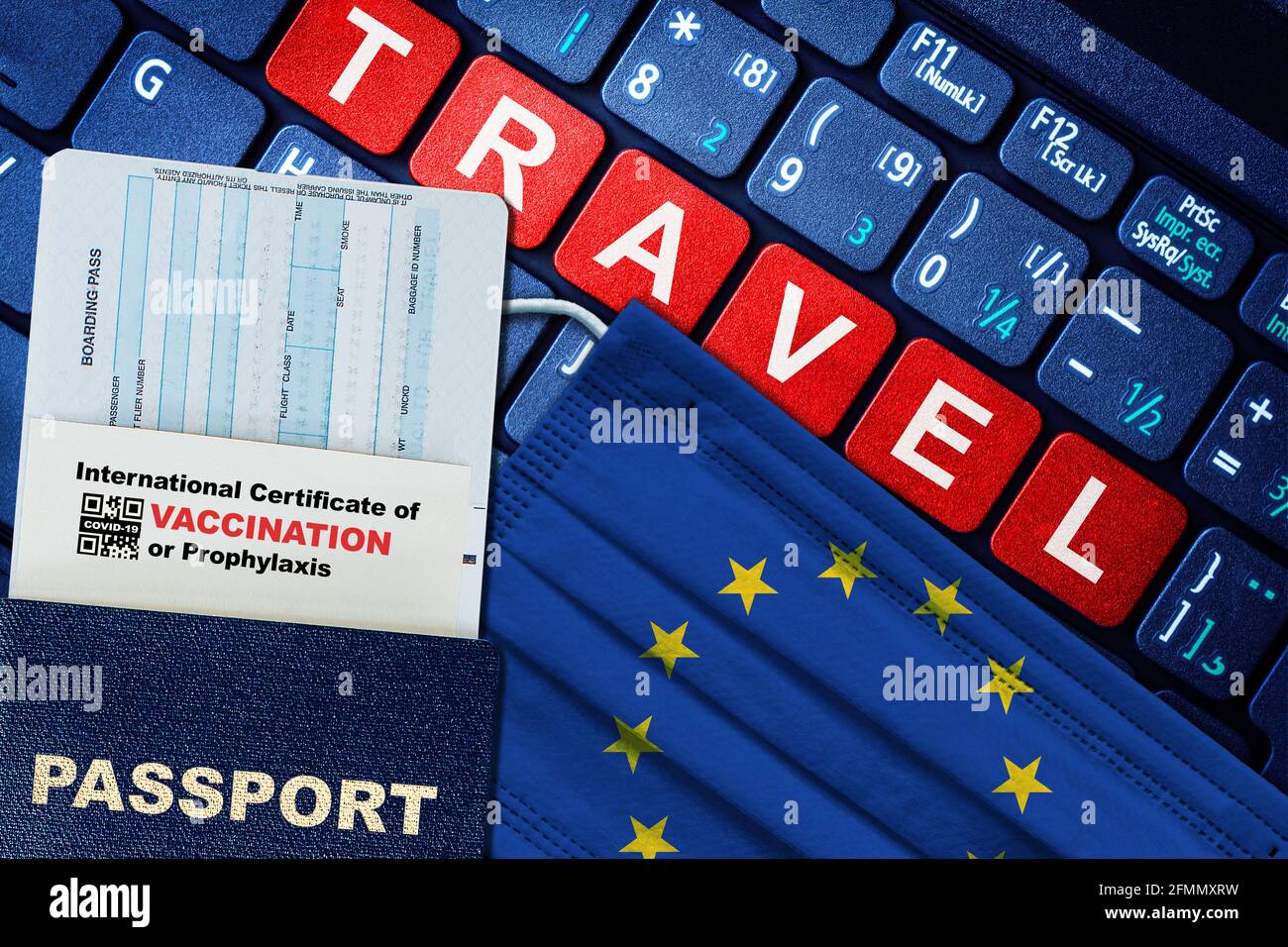 European Union new normal travel concept with passport, boarding pass, face mask with EU flag and certificate of COVID-19 vaccination on keyboard. Vac Stock Photo