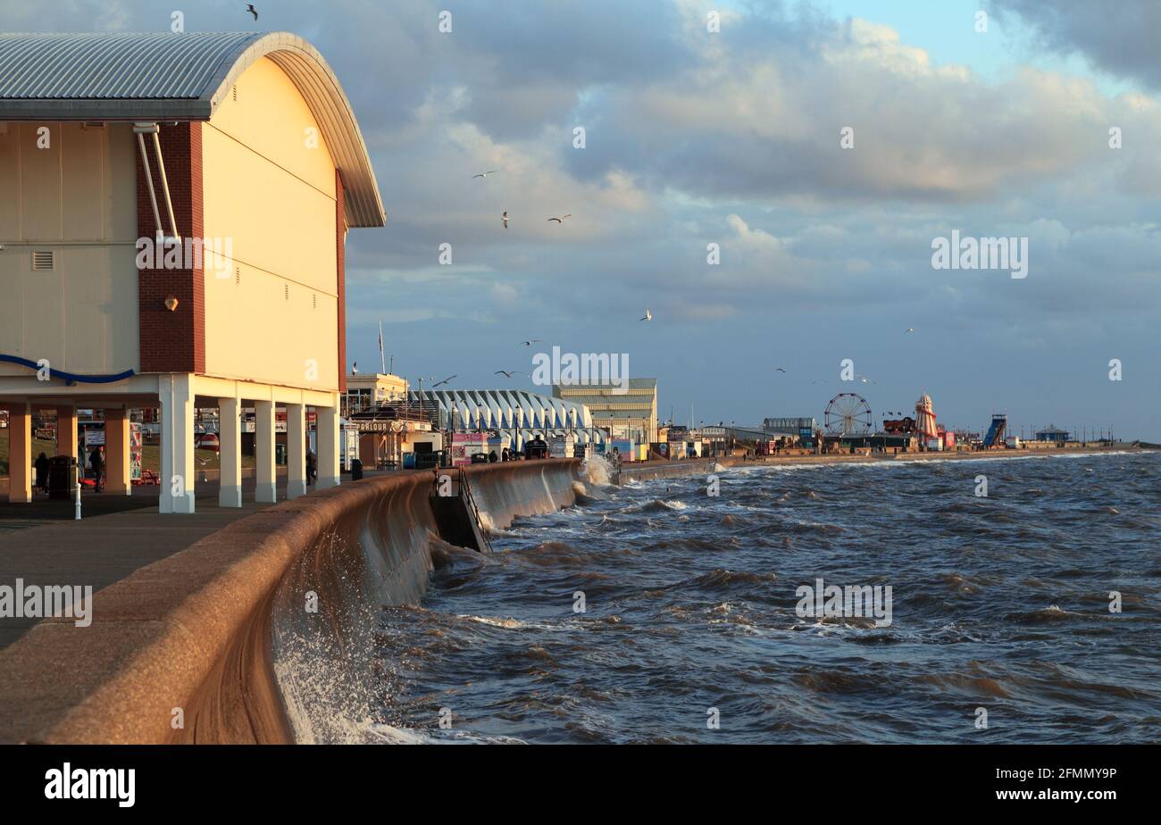 Hunstanton, sea front, amusements, funfair, high tide, sea wall, Norfolk, England Stock Photo