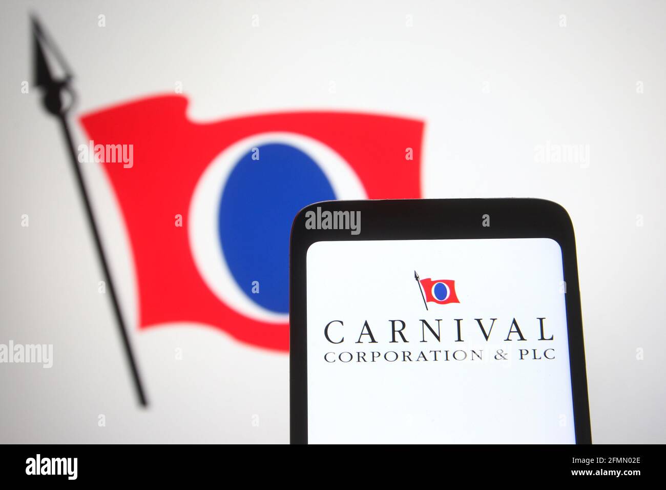 In this photo illustration the Carnival Corporation & plc logo is seen on a smartphone and a pc screen. Stock Photo