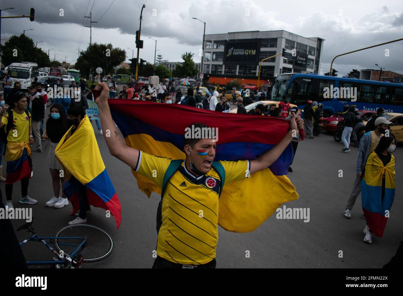 Bogota, Colombia, May 10, 2021, Demonstrators with Colombian flags participate in a protest as Bogota faces its 13 day of anti-government protests against the Health Reform and Police Brutality cases that rise to over 30 dead across the country since the National Strike begun. In Bogota, Colombia on May 10, 2021 Stock Photo